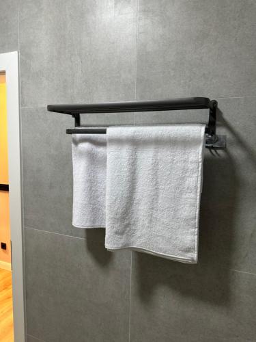 two towels hanging on a towel rack in a bathroom at Aparte - Tophane in Pristina