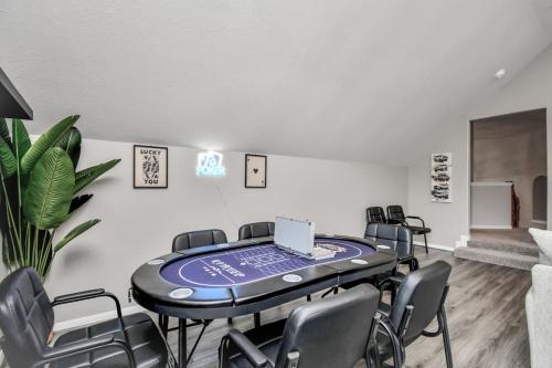 a room with a table with chairs and a laptop on it at The Woodlands Escape with Heated Pool and GameRoom in Conroe