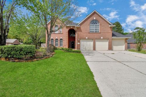 a large brick house with a driveway at The Woodlands Escape with Heated Pool and GameRoom in Conroe