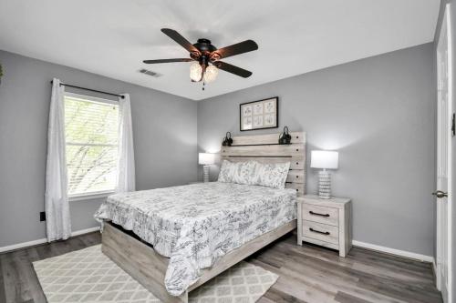 a bedroom with a bed and a ceiling fan at The Woodlands Escape with Heated Pool and GameRoom in Conroe