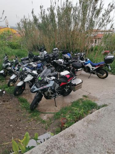 a group of motorcycles parked in a parking lot at AFFITTA CAMERE CASA DELLE ROSE in Villanova Monteleone
