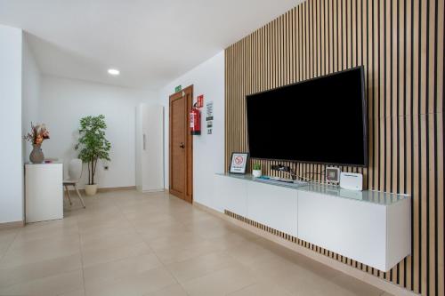 a living room with a flat screen tv on a wall at Eclipse in Puerto del Rosario