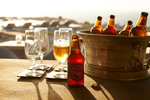 a group of bottles of beer and glasses on a table at Absolute Paradise Santorini in Akrotiri
