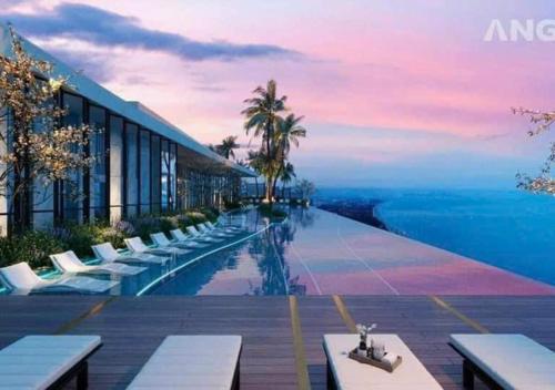 a hotel with a pool with a view of the ocean at The Sóng Vũng Tàu- SAO VIỆT Căn Hộ Nghỉ Dưỡng 5 Sao in Vung Tau