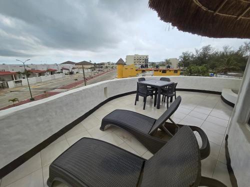 a balcony with chairs and a table on a roof at Hotel Villa Capricho in Ciudad Madero