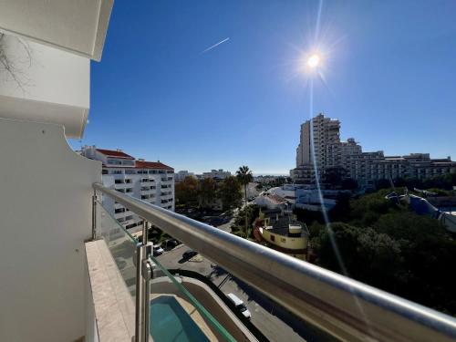a balcony with a view of a city at Albufeira Town Apartment With Pool by Homing in Albufeira
