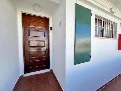 a hallway with a wooden door in a building at Albufeira Town Apartment With Pool by Homing in Albufeira