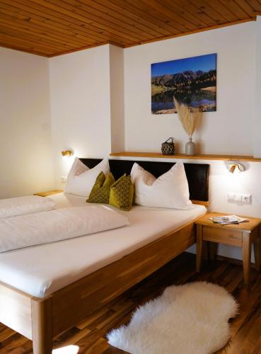a bedroom with two beds with pillows at Ferienhaus Bucheggerhof in Schladming