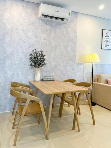 a dining room with a wooden table and chairs at The Song Boutique Apartment in Vung Tau