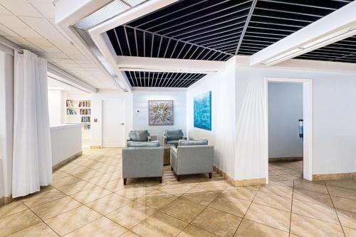 a lobby with chairs and a table in a building at Islander W 703 in Fort Walton Beach