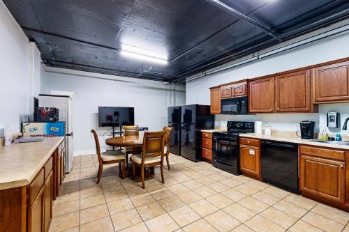 a kitchen with wooden cabinets and a table and chairs at Islander W 703 in Fort Walton Beach