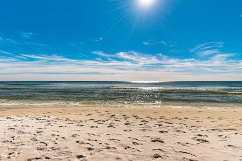 a beach with footprints in the sand and the ocean at Islander W 703 in Fort Walton Beach