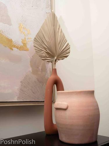 a brown vase with a fan sitting on a table at Luxury Beautiful Spacious Retreat Getaway in Columbus