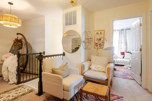 a living room with two chairs and a mirror at Luxury Beautiful Spacious Retreat Getaway in Columbus