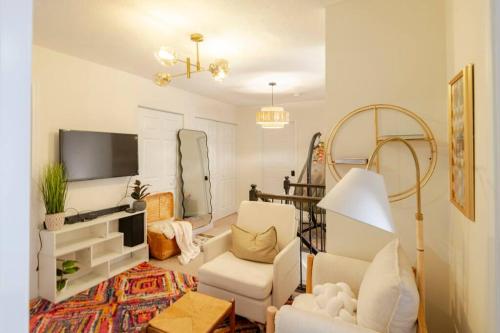 a living room with a white couch and a tv at Luxury Beautiful Spacious Retreat Getaway in Columbus