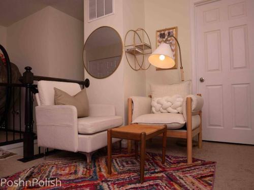 a living room with two chairs and a table and a mirror at Luxury Beautiful Spacious Retreat Getaway in Columbus