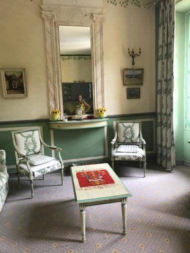 a room with two chairs and a mirror and a table at Chateau appartement tussen Mont Ventoux en Luberon in Montbrun-les-Bains