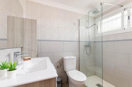 a bathroom with a toilet and a sink and a shower at Yourhouse El Xiprer in Pollença