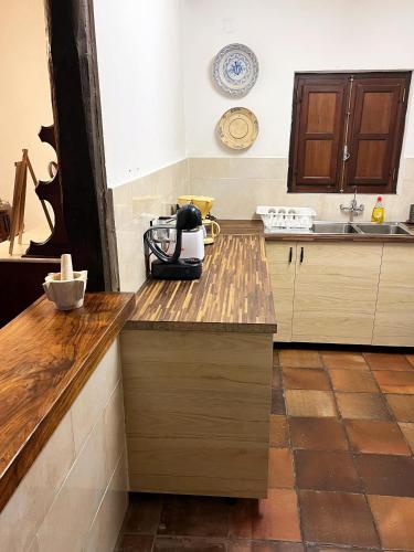 a kitchen with a mixer on a wooden counter top at Casa da Paz in Labrugeira