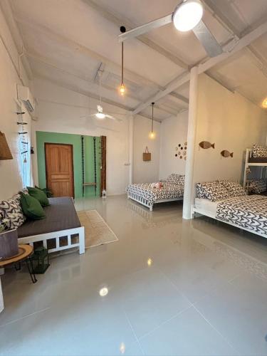 a large room with three beds in it at P Vacation Libong in Ko Libong