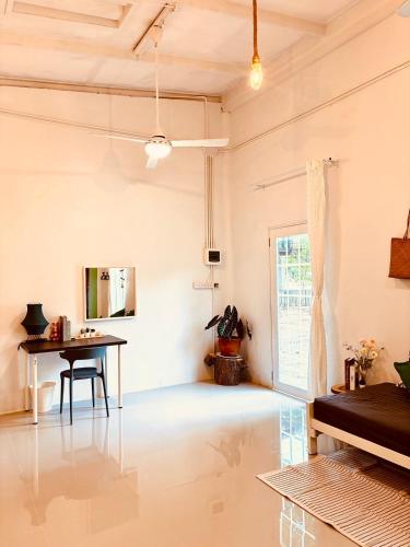 a living room with a table and a window at P Vacation Libong in Ko Libong