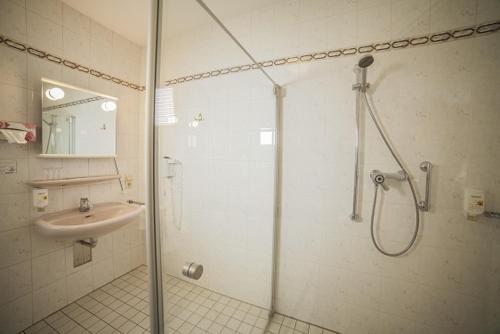 a bathroom with a shower and a sink at Akzent Hotel Gut Höing in Unna