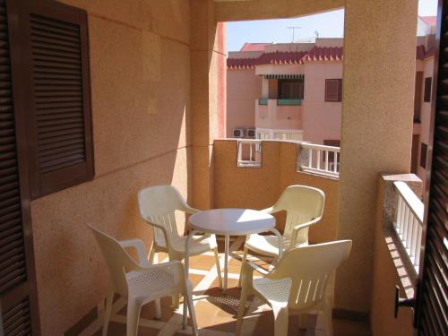 a patio with a table and chairs on a balcony at Apartamentos Tesy in La Manga del Mar Menor