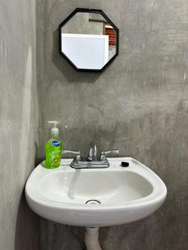 a bathroom sink with a mirror on the wall at Gloria del Mar in Tlachicón