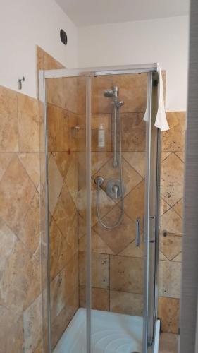 a shower with a glass enclosure in a bathroom at Rainbow Sweet Rooms in Valmontone