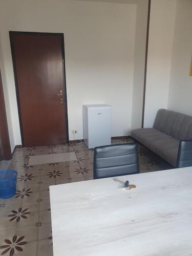 a living room with a table and a couch at Dc apartment in Santa Maria Capua Vetere