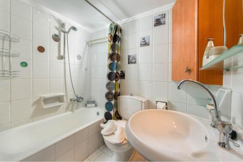 a bathroom with a sink and a toilet and a tub at Apartment Dream Holidays - 500 meters to beach in Ialyssos