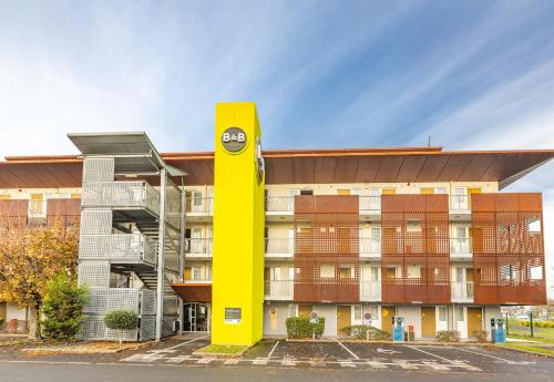 a yellow pole in front of a building at B&B HOTEL Saint-Malo Centre in Saint Malo