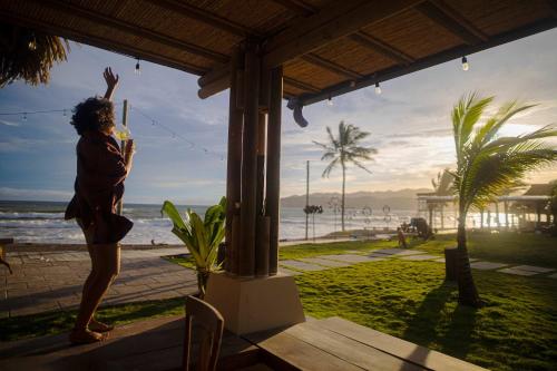 a woman standing on a porch looking at the ocean at Tasteful View 2BR Condo E31 at Playa Venao in Playa Venao