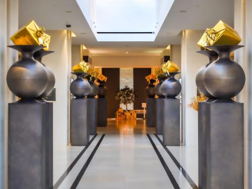 a hallway with black and gold vases on display at InterContinental Marseille - Hotel Dieu by IHG in Marseille