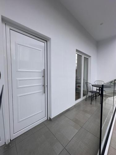 a room with a door and a table and chair at Joanna's Rooms in Kalopanayiotis