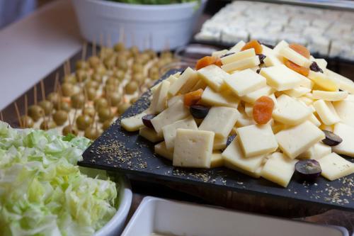 a plate of food with cheese and vegetables on a table at Ibersol Siurell in Sa Coma
