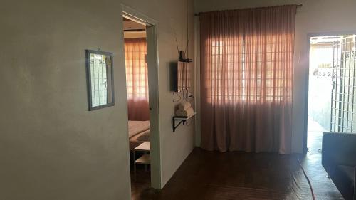 a room with a door leading to a bedroom at Atbas Homestay No 1 in Seri Iskandar