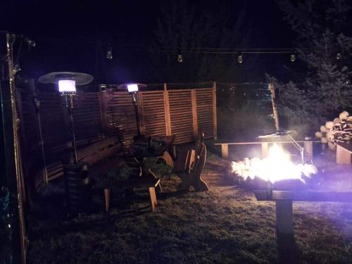 a fire grill in a yard at night at Chatka Oli in Zubacze