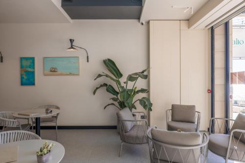 a waiting room with chairs and a potted plant at Deep Blu Boutique Hotel in Żurrieq