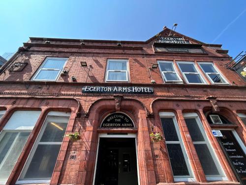 a red brick building with a sign on it at The Egerton Arms Hotel Salford in Manchester