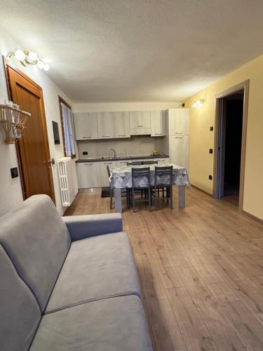 a living room with a couch and a table at Orobie Holiday Apartments in Albosaggia