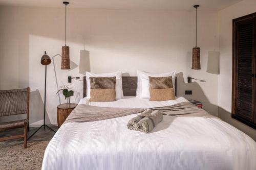 a bedroom with two beds with white sheets and pillows at Balmy Beach Resort Kemer in Kemer