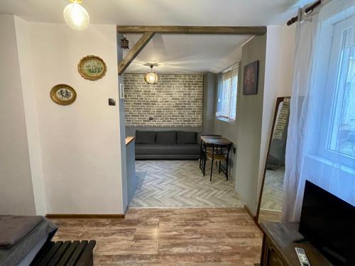 a living room with a couch and a table at Hot Spot Studio in the center in Sofia