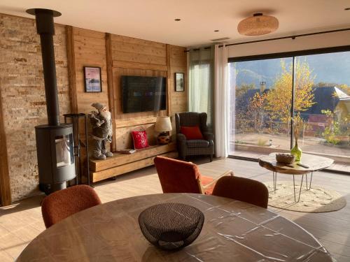 a living room with a table and a television at Le chalet Paula in Agos-Vidalos