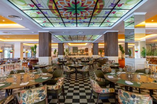 a restaurant with tables and chairs and a colorful ceiling at Bahia Principe Grand Jamaica - All Inclusive in Runaway Bay