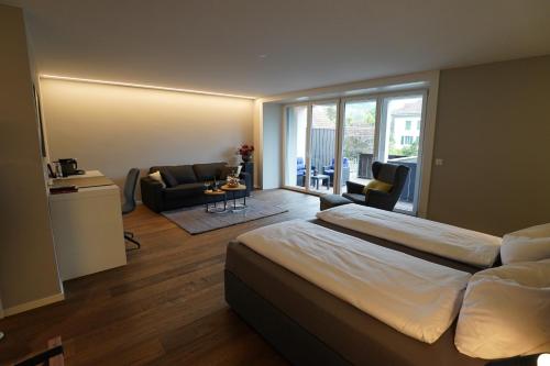 a bedroom with a bed and a living room at wolke 4 in Büren an der Aare