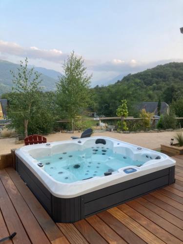 a jacuzzi tub sitting on a deck at Le chalet Paula in Agos-Vidalos