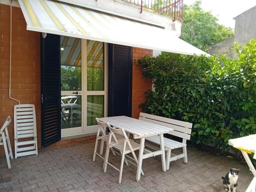 a wooden table and chairs on a patio at Marica House Spiaggia Coreca Amantea in Amantea