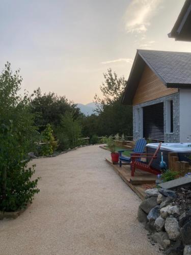 a house with a patio with chairs and a table at Le chalet Paula in Agos-Vidalos