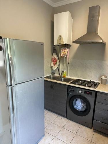 a kitchen with a refrigerator and a washing machine at Good dayy in Yerevan